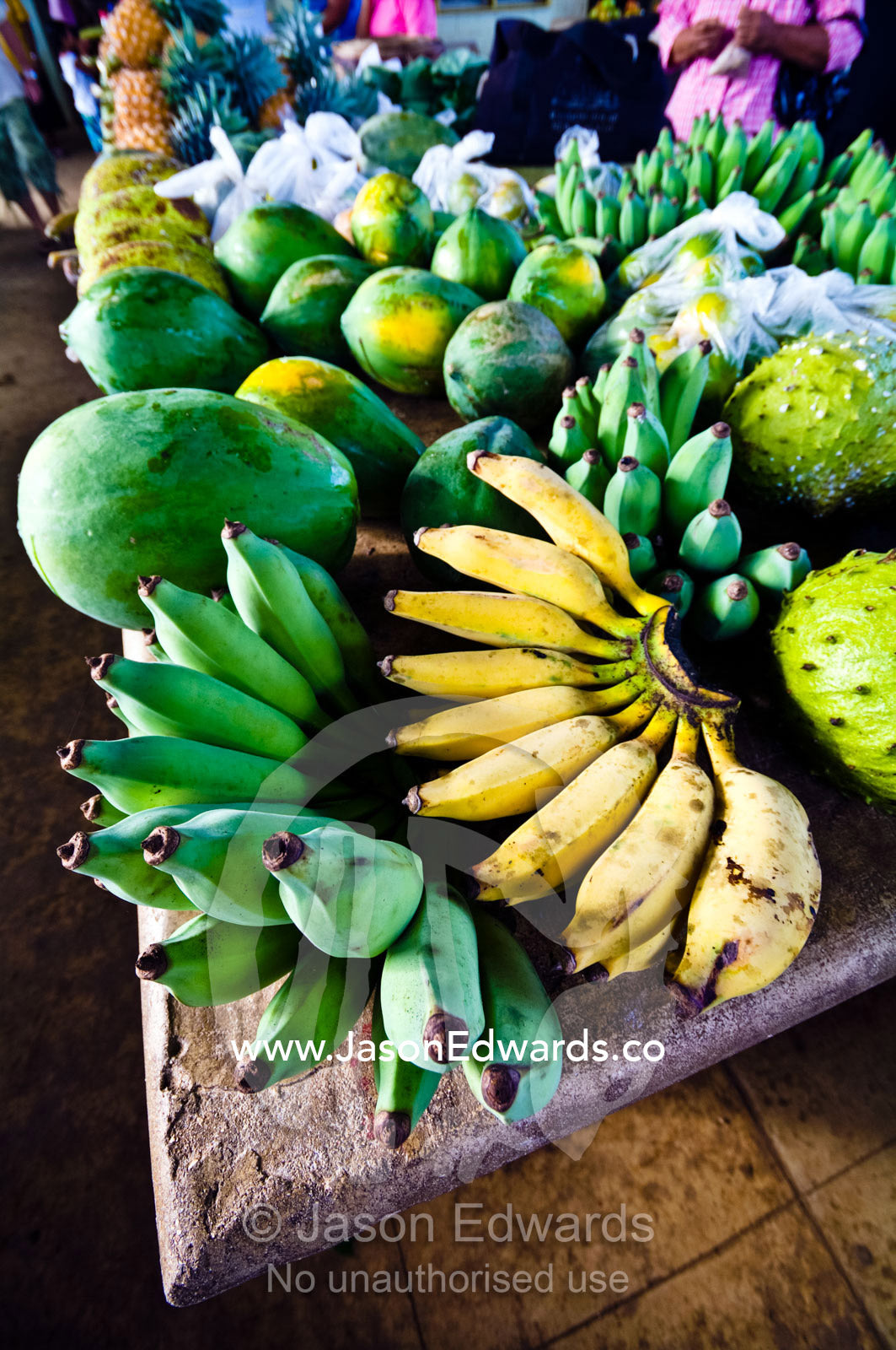 Ripe and unripe green bananas, papaya and breadfruit in a market. Utukalongalu Market, Port of Refuge, Neiafu, Vava'u Island Group, Pacific Ocean, Oceania, Kingdom of Tonga.