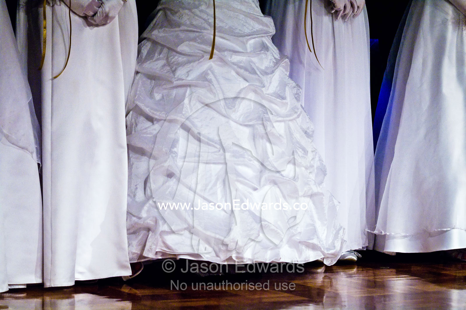 Teenage girls in white dresses on the dance floor at a debutante ball. Melbourne, Victoria, Australia.