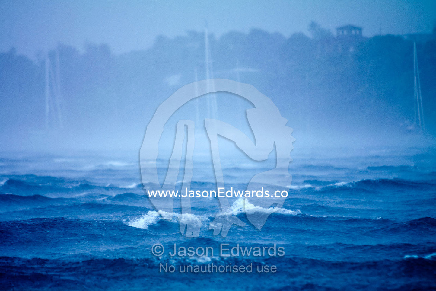 A tropical storm engulfs ocean yachts with gale force wind and rain. Port of Refuge, Neiafu, Vava'u Island Group, Pacific Ocean, Oceania, Kingdom of Tonga.