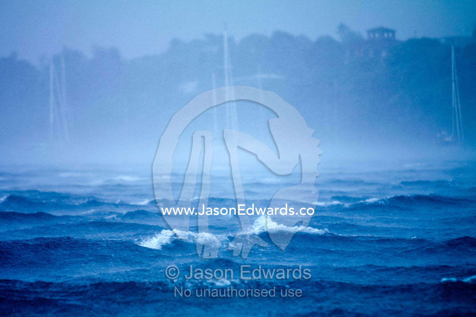 A tropical storm engulfs ocean yachts with gale force wind and rain. Port of Refuge, Neiafu, Vava'u Island Group, Pacific Ocean, Oceania, Kingdom of Tonga.