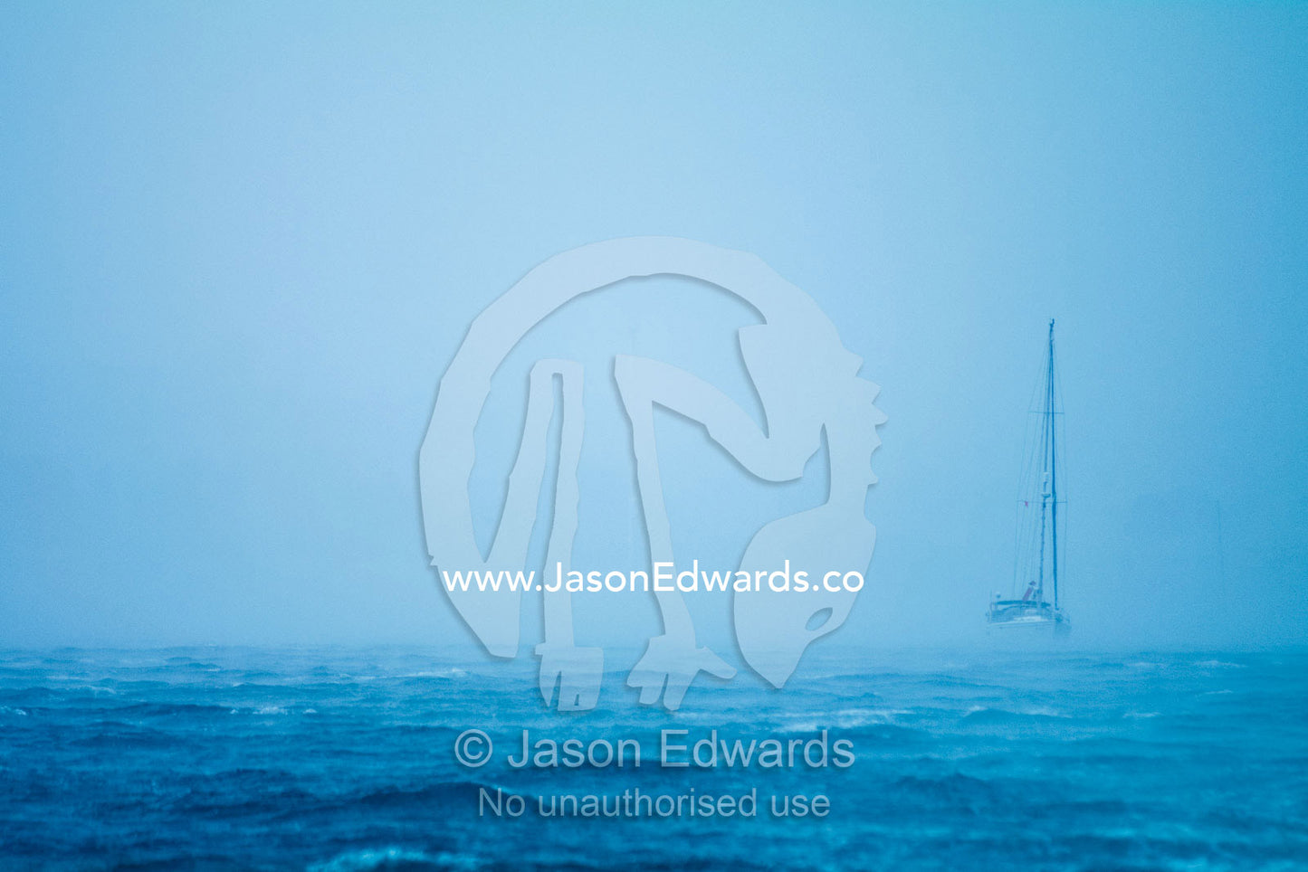 A tropical storm engulfs an ocean yacht with gale force wind and rain. Port of Refuge, Neiafu, Vava'u Island Group, Pacific Ocean, Oceania, Kingdom of Tonga.