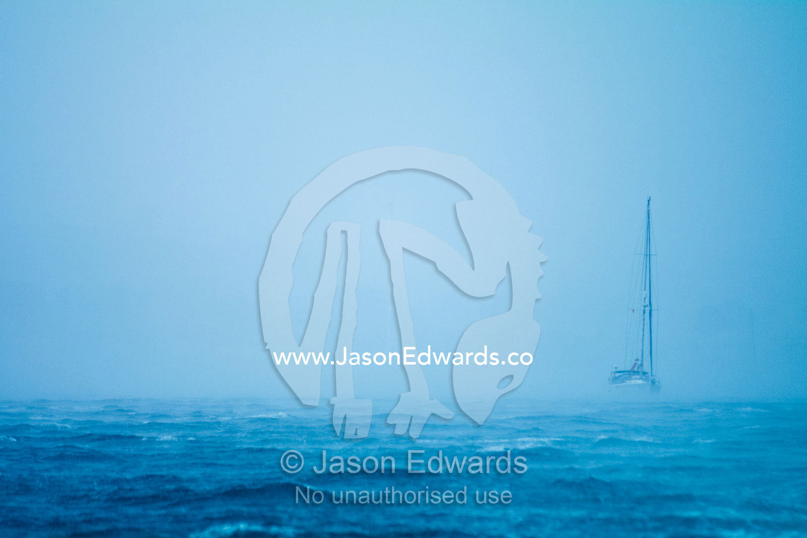 A tropical storm engulfs an ocean yacht with gale force wind and rain. Port of Refuge, Neiafu, Vava'u Island Group, Pacific Ocean, Oceania, Kingdom of Tonga.