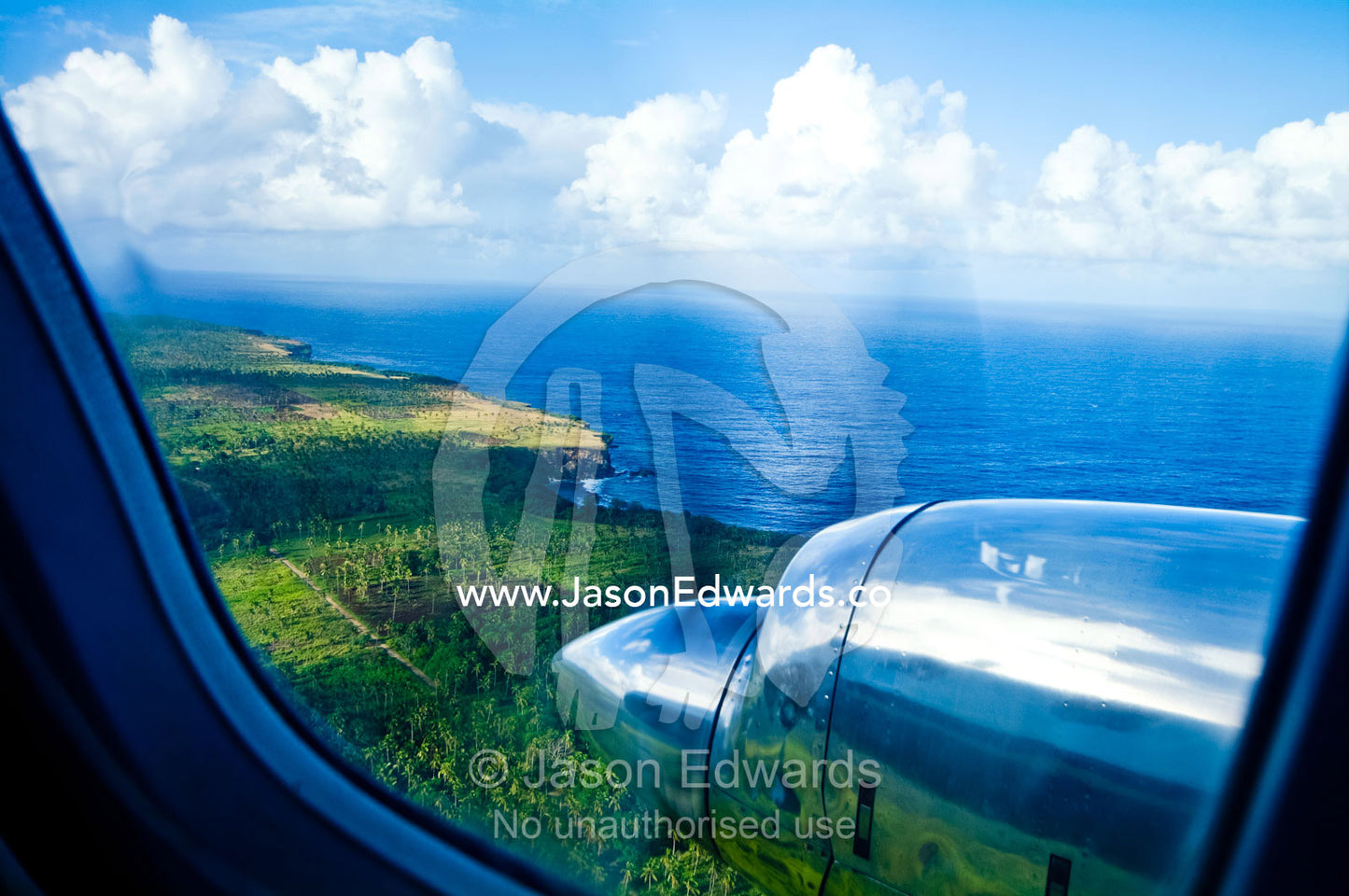A chrome engine and propellor of a plane flying over tropical islands. Tongatapu, Pacific Ocean, Oceania, Kingdom of Tonga.