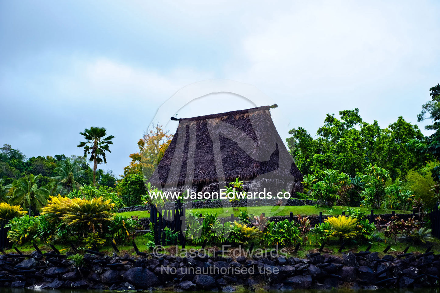 A traditional Chief's Bure with thatched roof atop a tropical hill. Pacific Harbour Arts Village, Deuba, Viti Levu, Pacific Ocean, Fiji Islands.