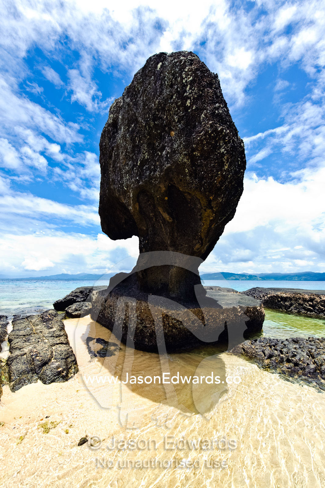A rock pillar exposed by the low tide on a remote island beach. Tabiang Village, Rabi Island, Somosomo Strait, Pacific Ocean, Fiji Islands.