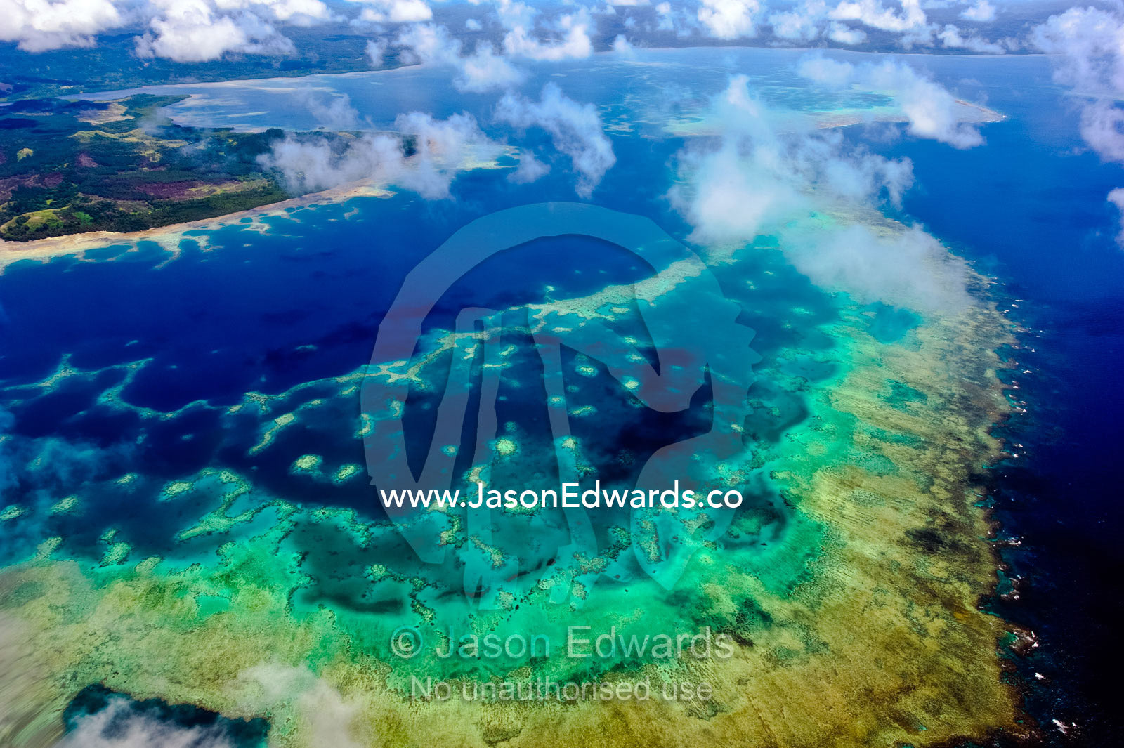 A vast pristine coral reef surrounding a tropical island. Pacific Ocean, Somosomo Strait, Fiji Islands.