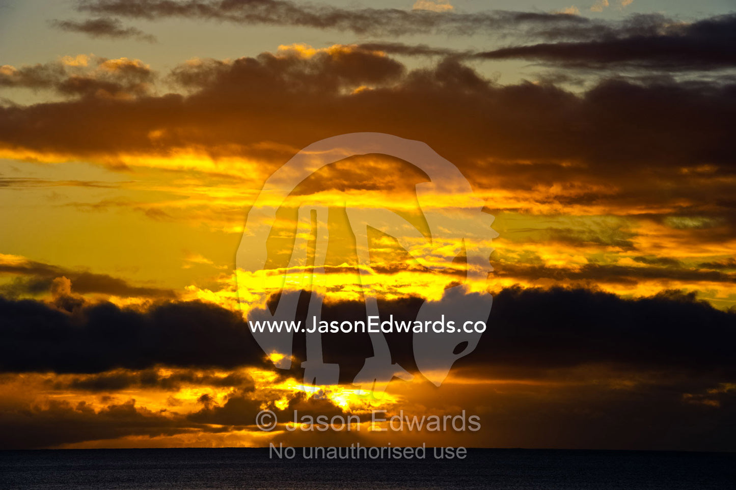 A tropical storm forms over the ocean horizon at sunset. Taveuni Island, Somosomo Strait, Pacific Ocean, Fiji Islands.