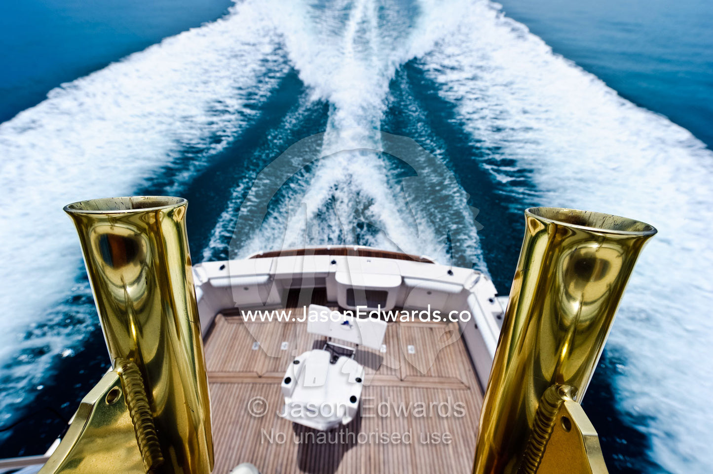 Brass fishing rod holders on a luxury speed boat deep sea fishing. Momi Bay, Veti Levu, Pacific Ocean, Fiji Islands.