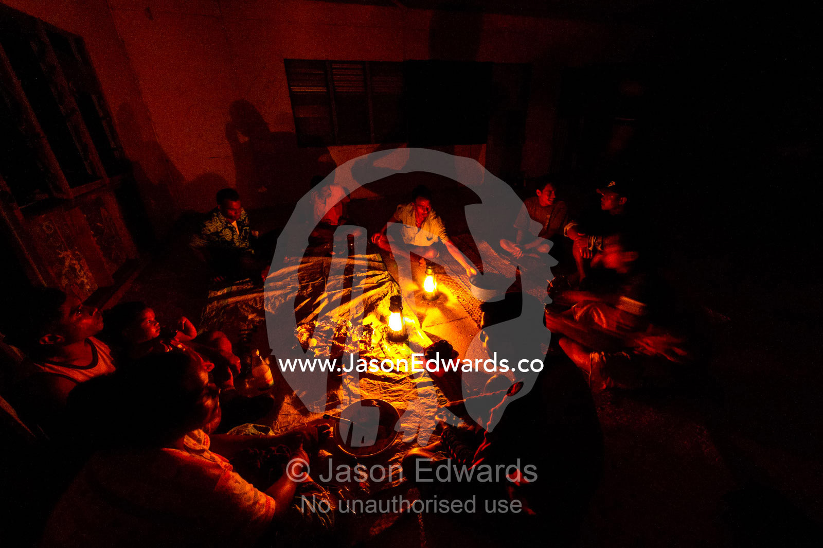 Villagers enjoy a kava ceremony in a schoolhouse by kerosene lanterns. Rabi Island, Somosomo Strait, Pacific Ocean, Fiji Islands.