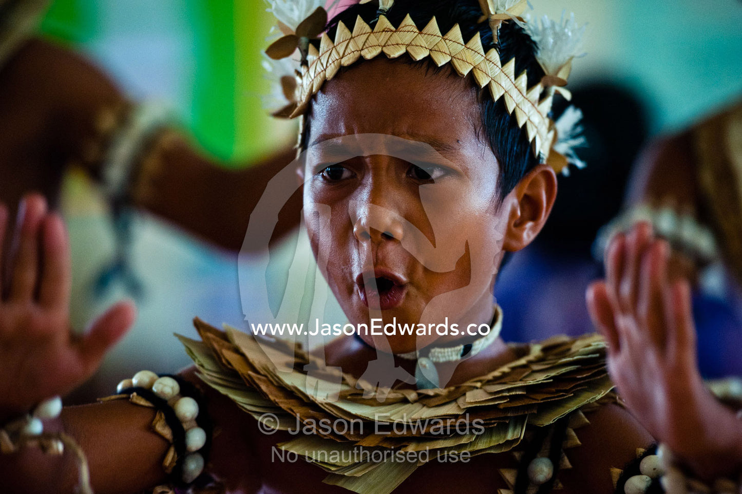 A Micronesian boy performs a war dance dressed in seashells and leaves Tabiang Village, Rabi Island, Somosomo Strait, Pacific Ocean, Fiji Islands.