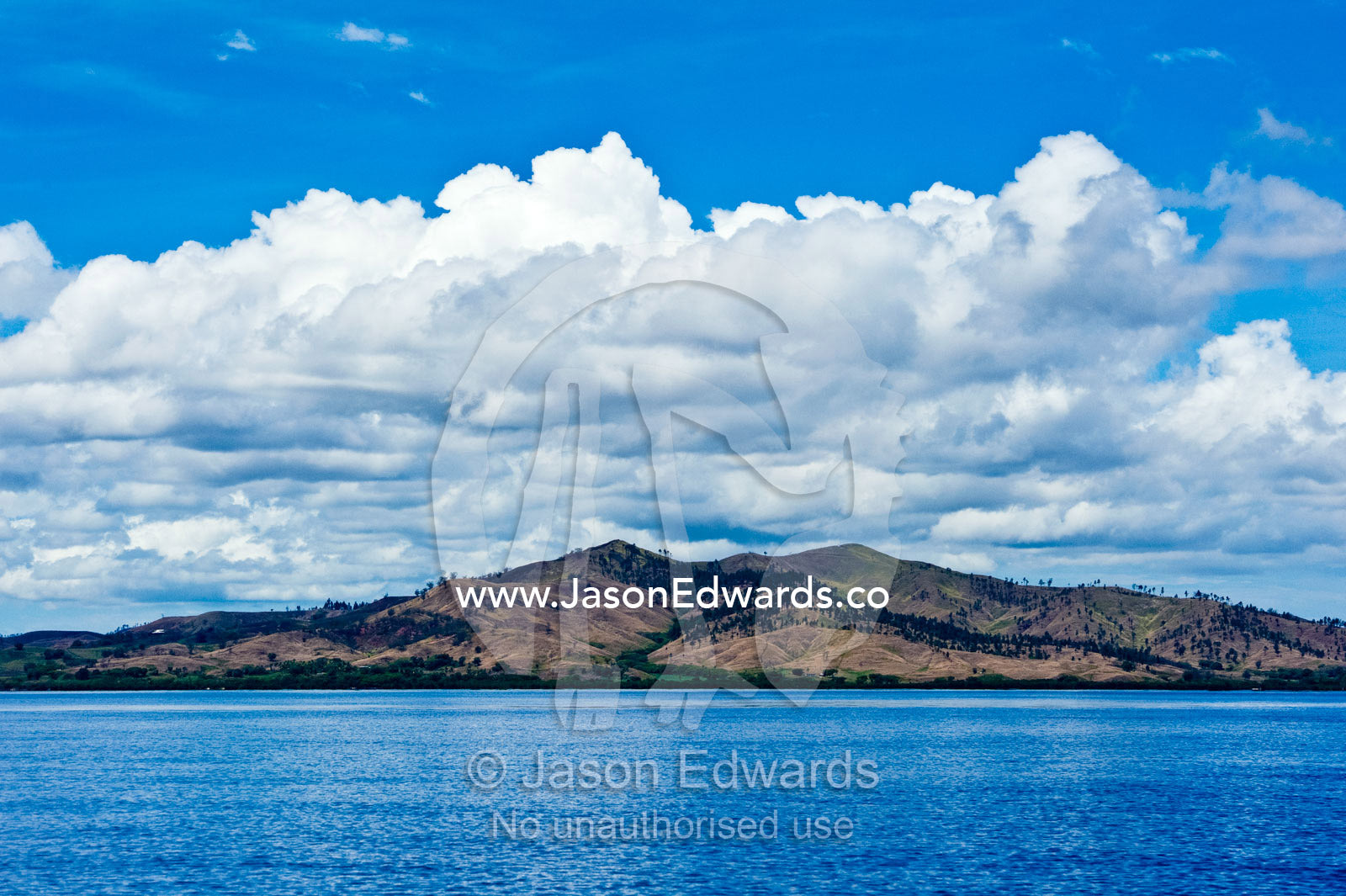 A denuded tropical island cleared for farmland and agriculture. Momi Bay, Viti Levu, Pacific Ocean, Fiji Islands.