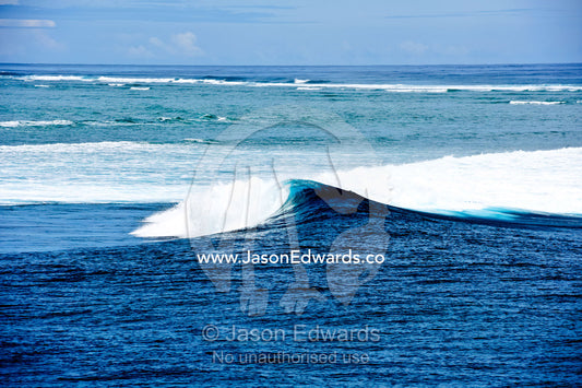 An empty peeling wave on the famous surfing reef known as Cloudbreak. Cloudbreak Reef, Tavarua Island, Pacific Ocean, Fiji Islands.