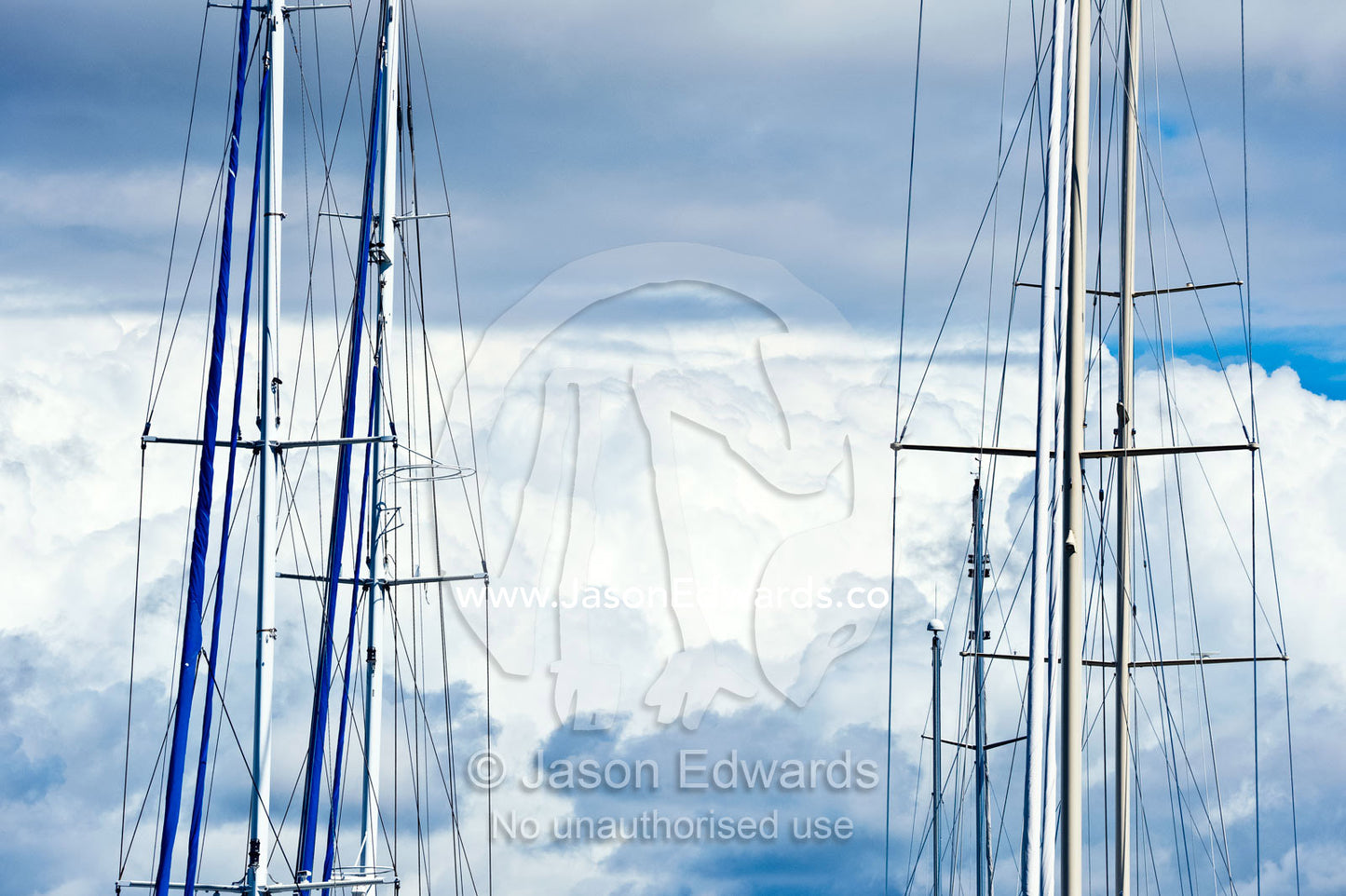 The masts and rigging of yachts at anchor in a marina. Momi Bay, Viti Levu, Malolo Archipelago, Pacific Ocean, Fiji Islands.