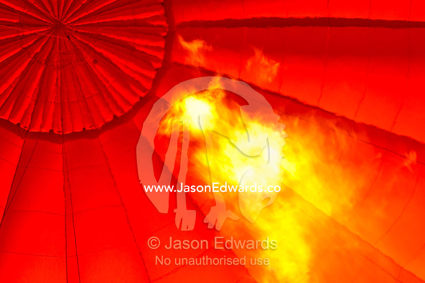 Flame blasts into the canopy of a balloon filling it with hot air. Viti Levu, Pacific Ocean, Fiji Islands.