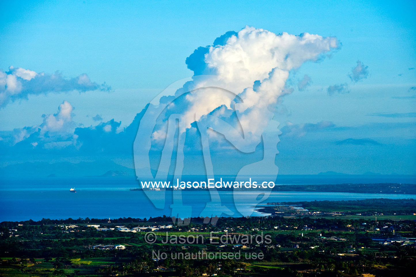 A large cumulus congestus develops over a tropical Fijian farming bay. Viti Levu, Malolo Archipelago, Pacific Ocean, Fiji Islands.