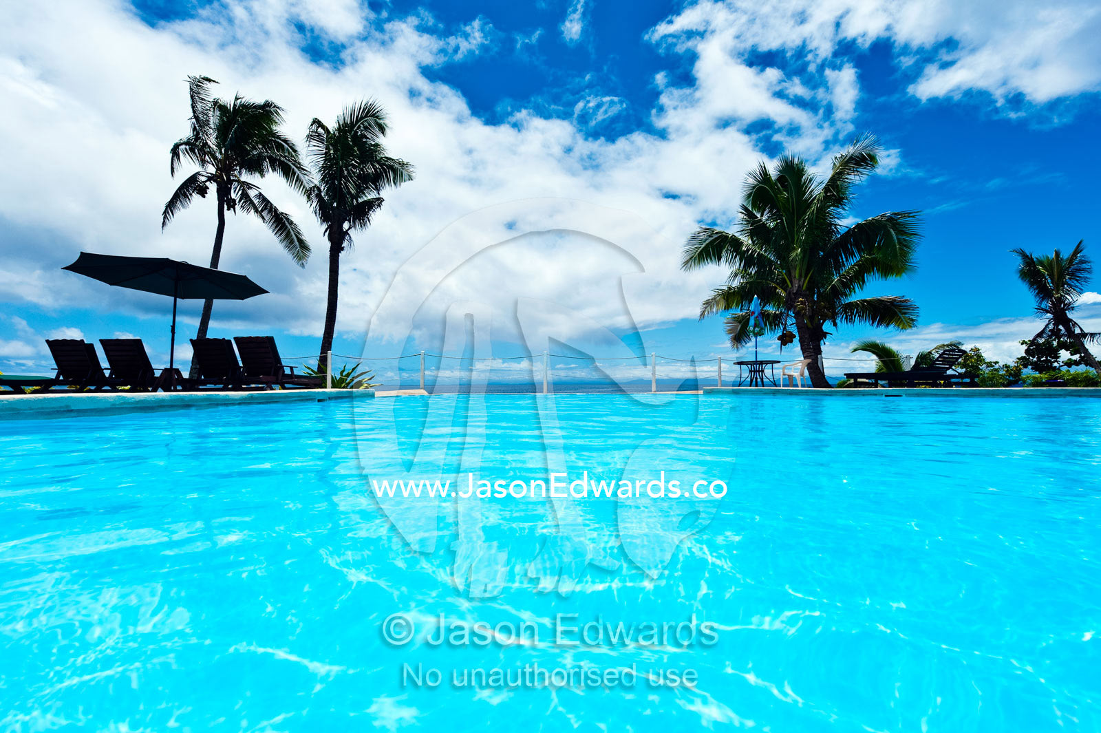 A relaxing horizon pool overlooking the ocean at a tropical resort. Taveuni Island, Pacific Ocean, Fiji Islands.