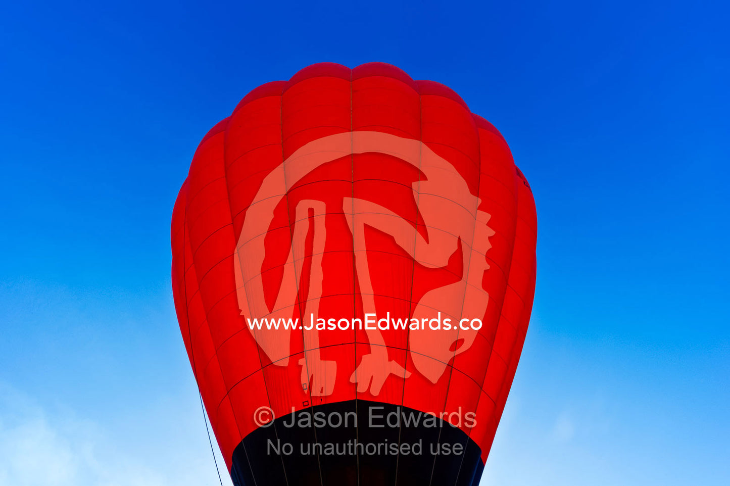 The inflated canopy of a hot air balloon backlit by the rising sun. Viti Levu, Pacific Ocean, Fiji Islands.