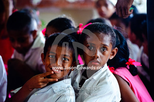 Micronesian boys watch a dance performance by school students. Tabiang Village, Rabi Island, Somosomo Strait, Pacific Ocean, Fiji Islands.
