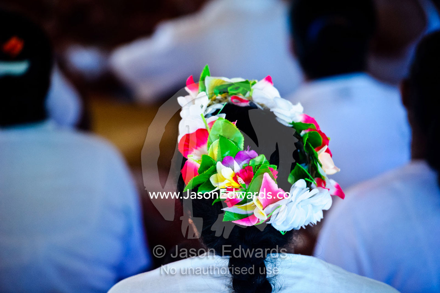 A girl with her hair adorned with a garland of flowers for a Fatele ceremony. Kioa Island, Somosomo Strait, Pacific Ocean, Fiji Islands.
