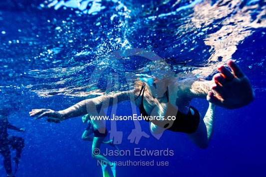 Tourists snorkel on the ocean surface looking for Manta Rays. Rabi Island, Somosomo Strait, Pacific Ocean, Fiji Islands.