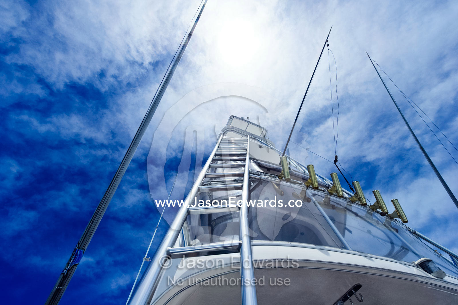 A ladder leads to the cockpit of a luxury speed boat and fishing rods. Momi Bay, Viti Levu, Malolo Archipelago, Pacific Ocean, Fiji Islands.
