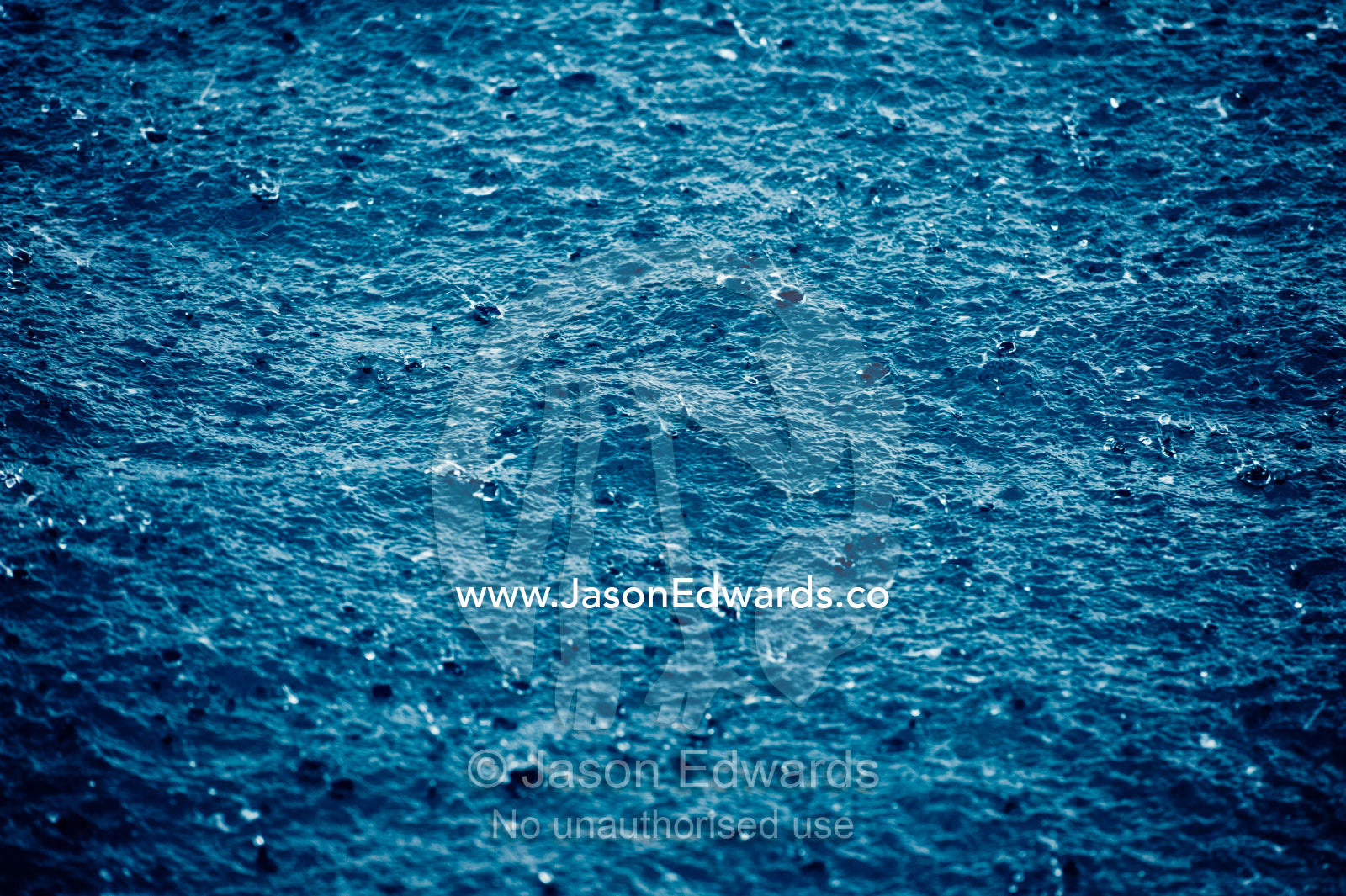 Torrential tropical downpours send raindrops into the ocean surface. Cobia Island, Ringgold Atolls, Pacific Ocean, Fiji Islands.