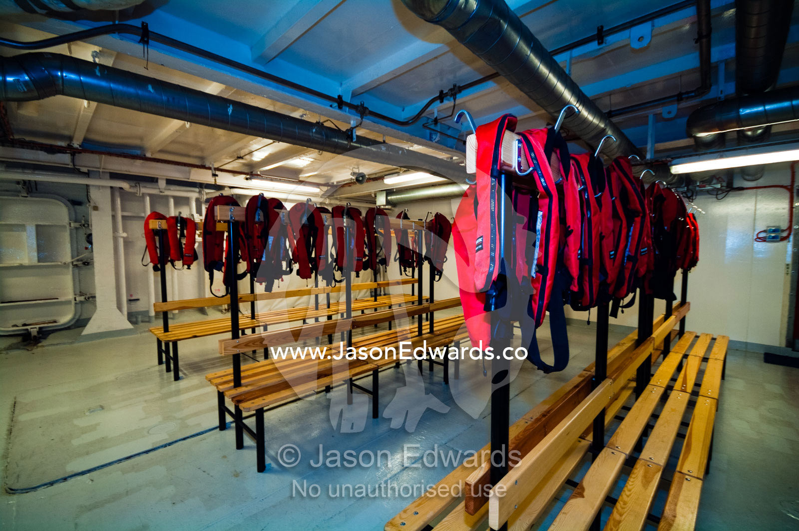Life jackets for tourists in the mud room of an Antarctic ship's hull. The Beagle Channel, Tierra del Fuego Archipelago, Strait of Magellan, Ushuaia, Tierra del Fuego Province, Patagonia, Argentina.