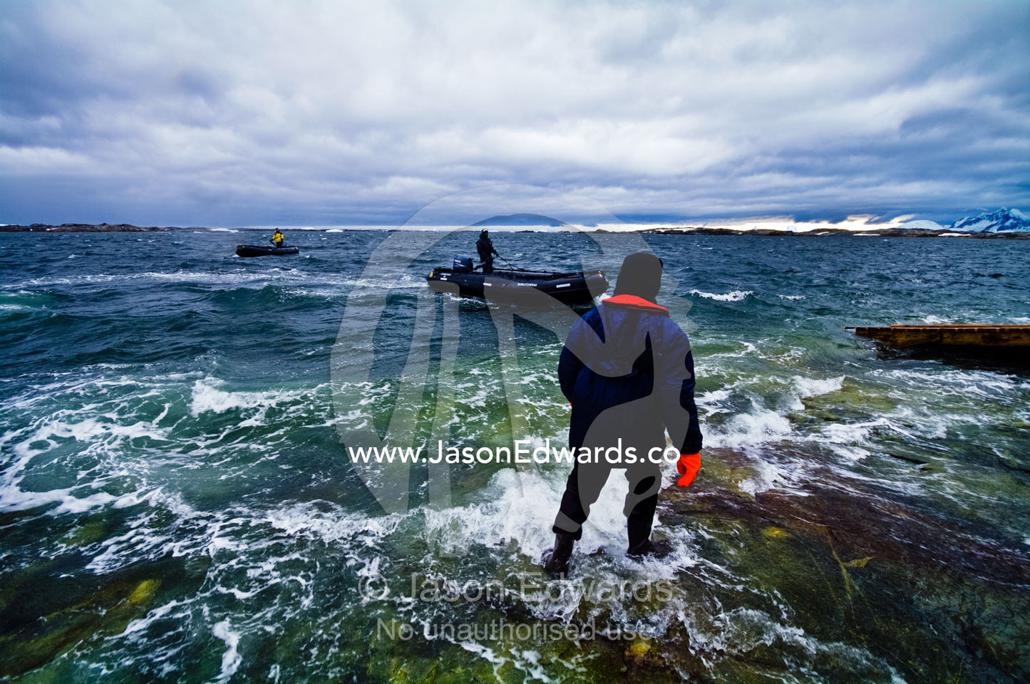 Ship's crew in insulated waterproof suits about to load zodiac boats. Vernadsky Antarctic Research Base, Galindez Island, Argentine Islands, Faraday Islands, Antarctic Peninsula, Antarctica.
