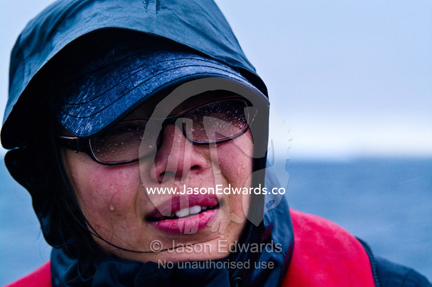 A tourist doused in icy rain suffering from severe cold in Antarctica. Pleneau and Booth Islands, Bellingshausen Sea, Antarctic Peninsula, Antarctica.