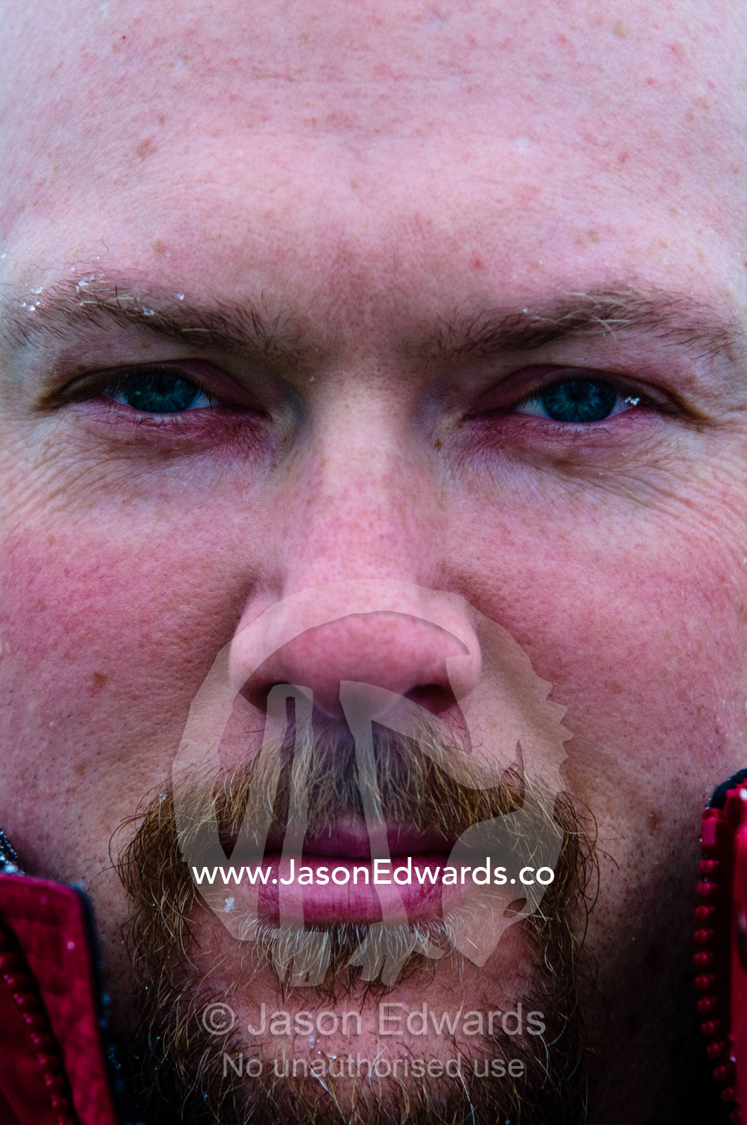 A tourist's intense stare as he exhales steam from his nostrils. Pleneau and Booth Islands, Bellingshausen Sea, Antarctic Peninsula, Antarctica.