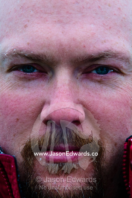 A tourist's intense stare as he exhales steam from his nostrils. Pleneau and Booth Islands, Bellingshausen Sea, Antarctic Peninsula, Antarctica.