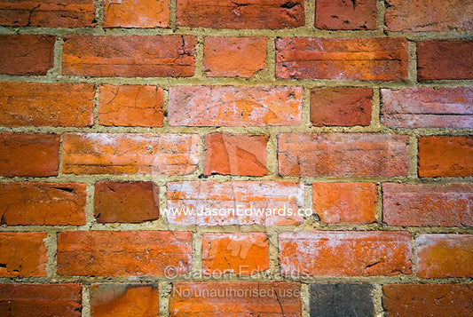 A weathered wall in a small country church made of red bricks. Elphinstone, Victoria, Australia.