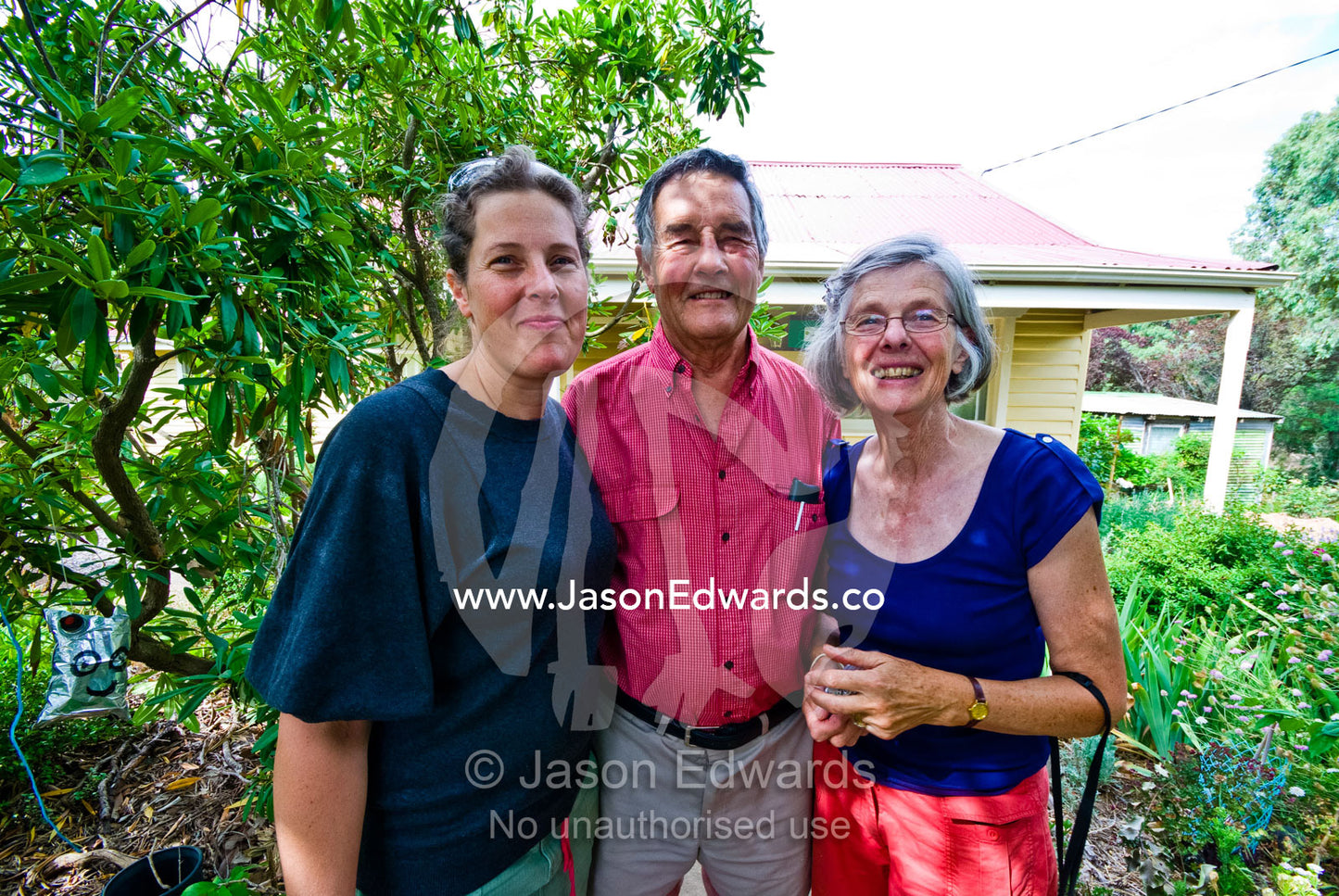 Family portrait of a daughter and her elderly parents in the country. Castlemaine, Victoria, Australia.