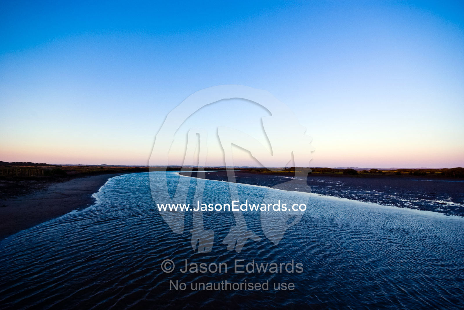 Twilight descends over a wide, tranquil tidal river and mud flat. Anderson's Inlet, Venus Bay, South Gippsland, Victoria, Australia.