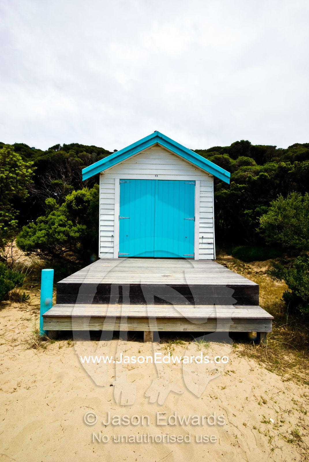 The bright blue door of a shack known as a bathing box on the beach. Rye Beach, Melbourne, Victoria, Australia.