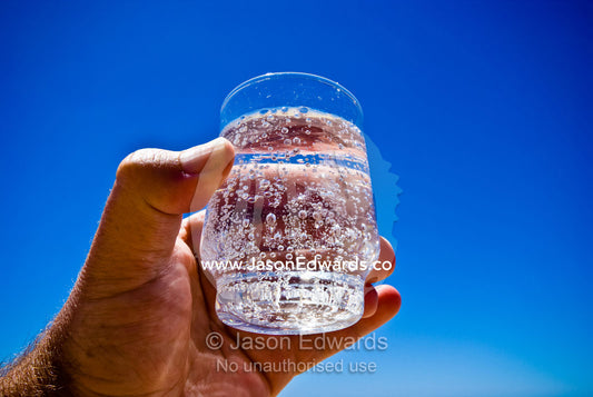 A cool, refreshing glass of sparkling mineral water on a summers day. Rye Beach, Melbourne, Victoria, Australia.