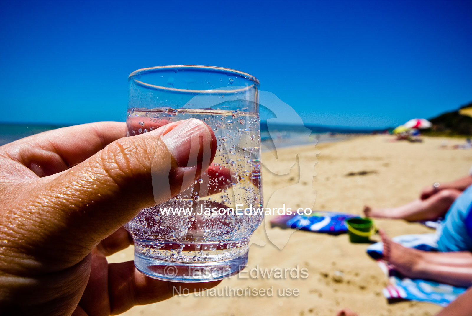 A cool, refreshing glass of sparkling mineral water on a summers day. Rye Beach, Melbourne, Victoria, Australia.