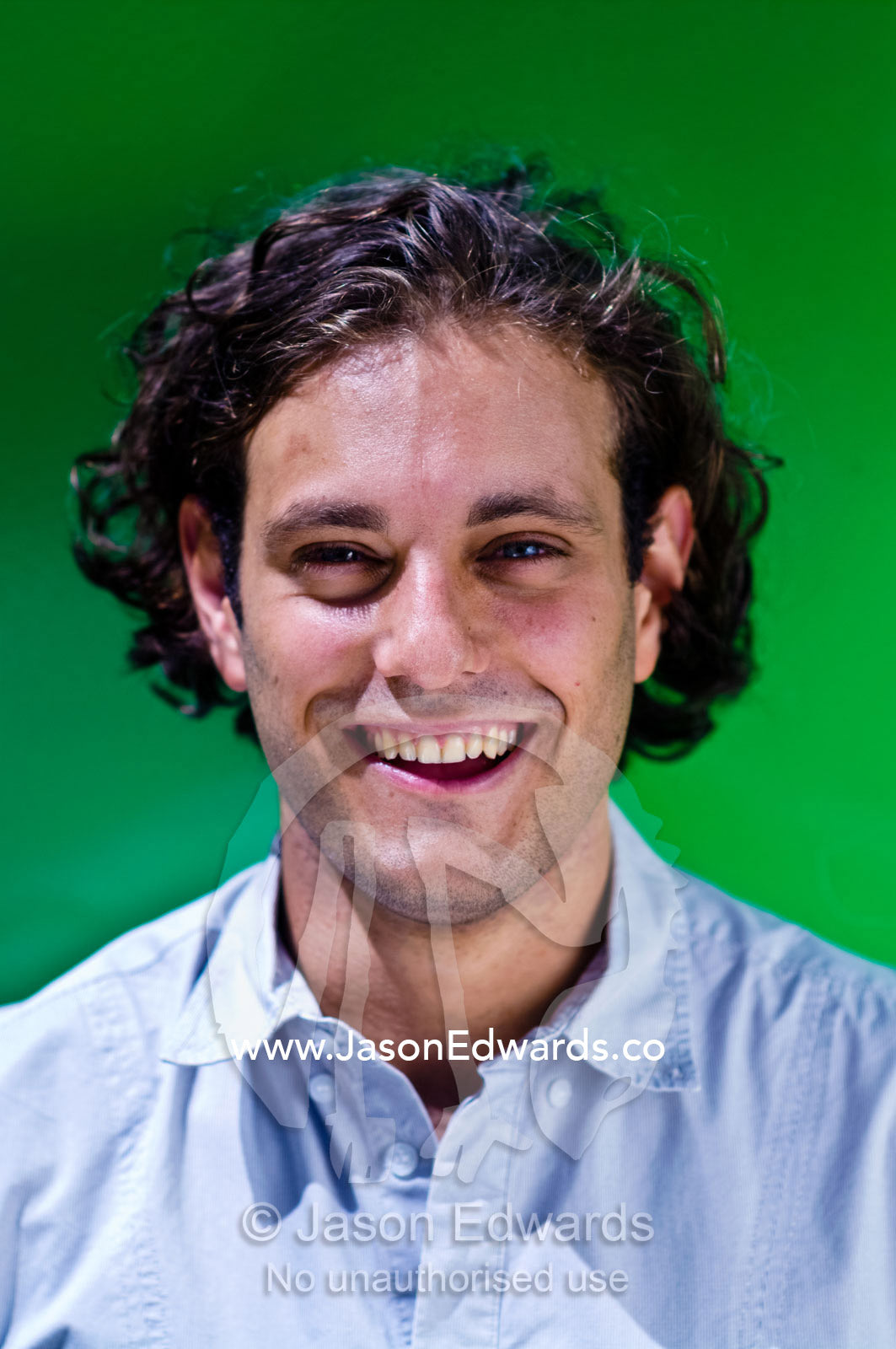 A portrait of a well-dressed young and attractive man laughing. Carlton, Melbourne, Victoria, Australia.