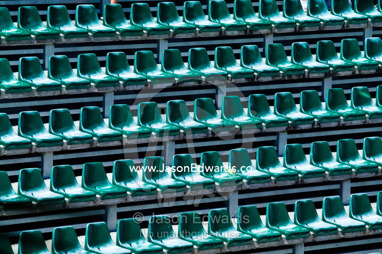 Empty rows of green plastic chairs in a stadium balcony stand. Crocoseum, Australia Zoo, Beerwah, Queensland, Australia.