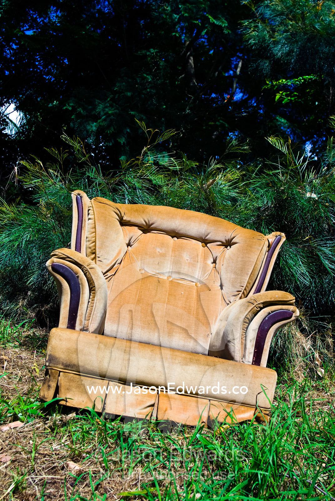 An old armchair by the roadside waiting as garbage or for adoption. Witta, Sunshine Coast, Brisbane, Queensland, Australia.