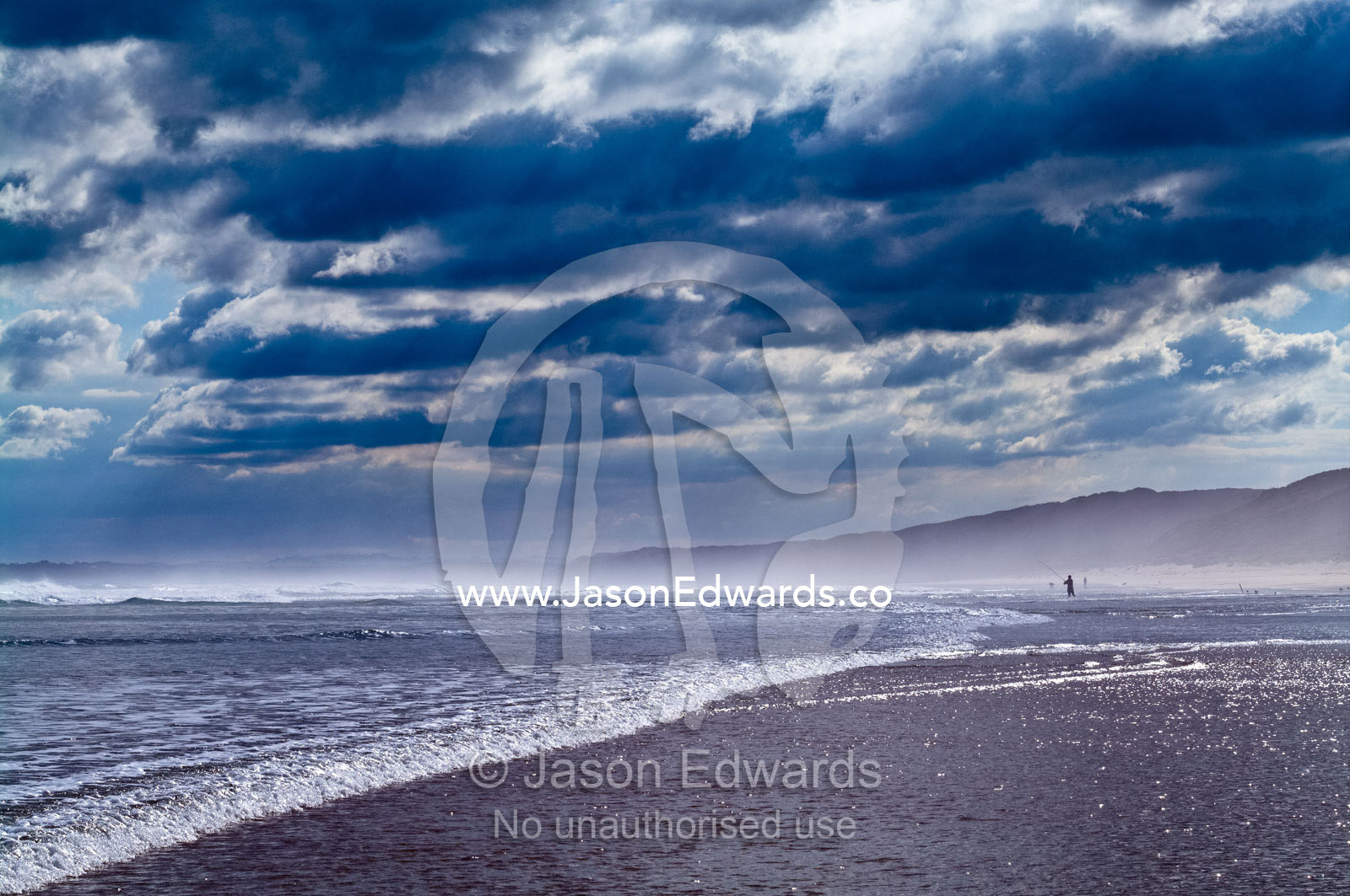 A dark and menacing storm rolls in over a wide beach at low tide. Venus Bay, Bass Strait, South Gippsland, Victoria, Australia.