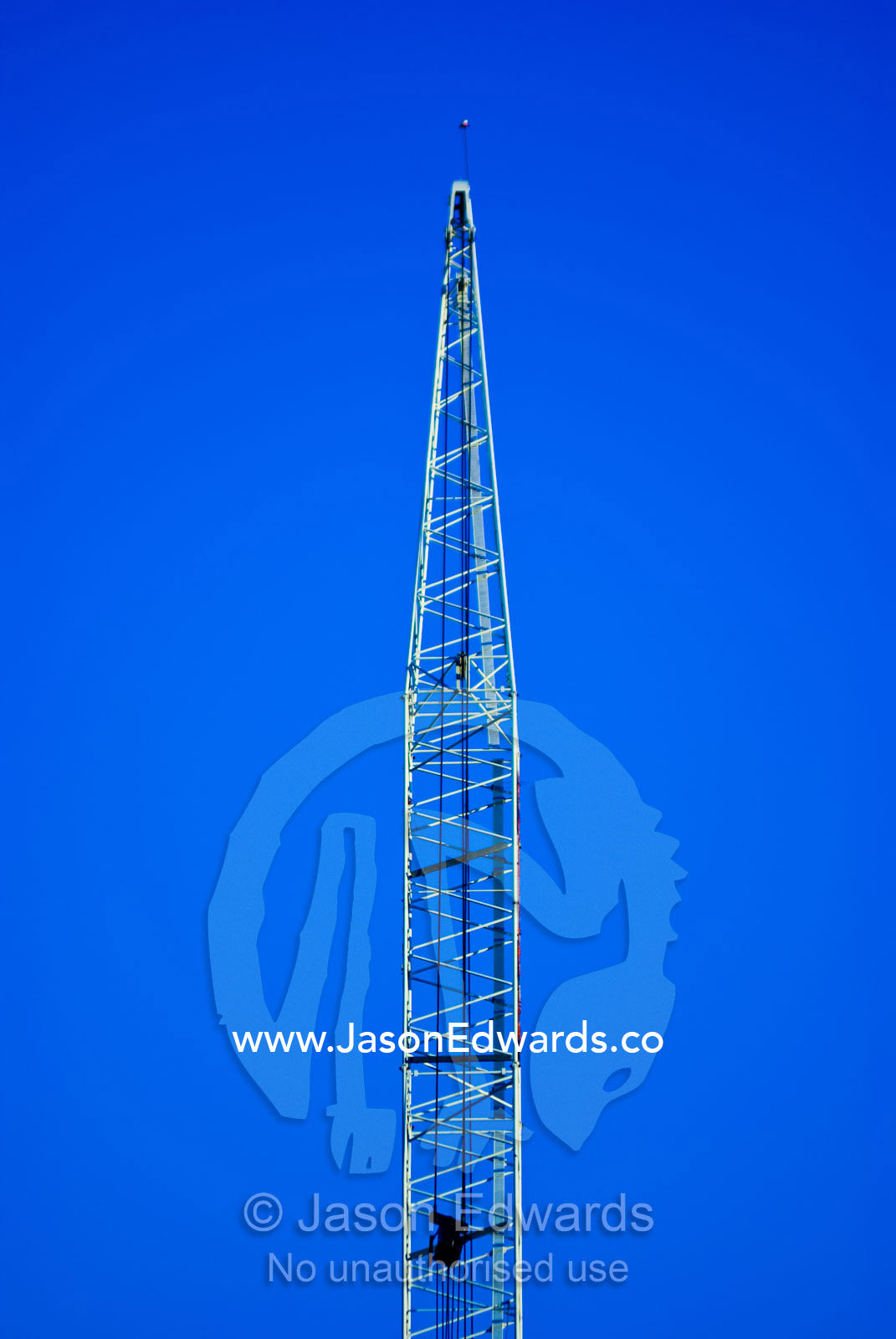 The steel lattice of a crane gantry rises into a clear blue sky. Melbourne, Victoria, Australia.