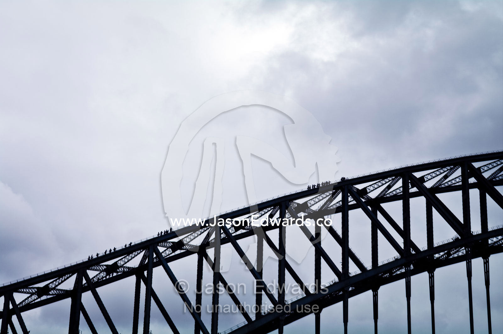 Huge steel girders dwarf tourists climbing the Sydney Harbour Bridge. Sydney Harbour, Sydney Cove, Warrane, Port Jackson, Circular Quay, Sydney, New South Wales, Australia.