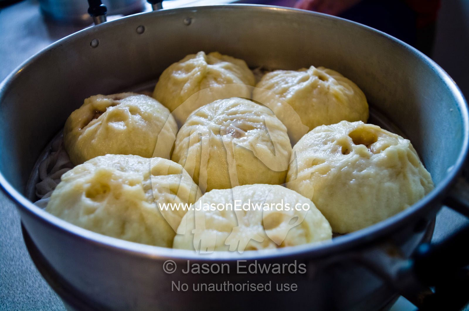 Freshly cooked traditional pork buns, baoze, in a hot kitchen steamer. Campsie, Syndey, New South Wales, Australia.