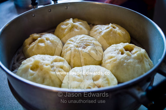 Freshly cooked traditional pork buns, baoze, in a hot kitchen steamer. Campsie, Syndey, New South Wales, Australia.