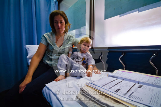 A mother comforts her son before he undergoes ear surgery in hospital. Epworth Freemasons Hospital, East Melbourne, Victoria, Australia.
