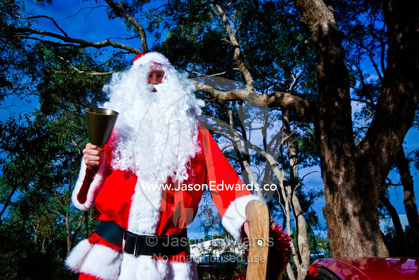 In a country town Father Christmas rings his bell from a utility truck. Castlemaine, Victoria, Australia.