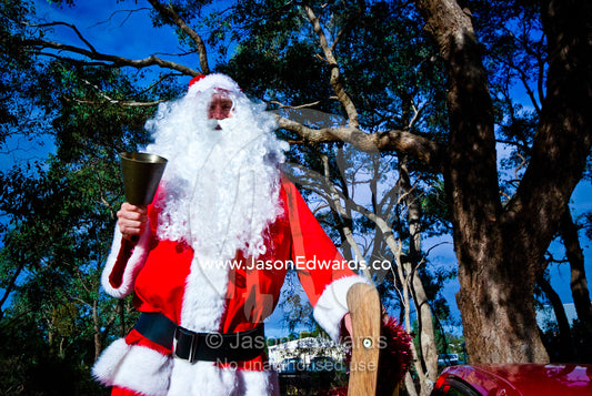In a country town Father Christmas rings his bell from a utility truck. Castlemaine, Victoria, Australia.