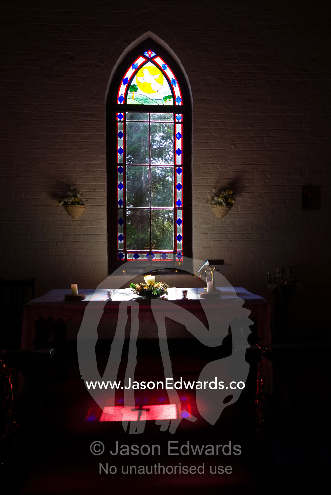 Sunshine illuminates a country church altar on Christmas morning. St Mary's Church, Elphinstone, Victoria, Australia.