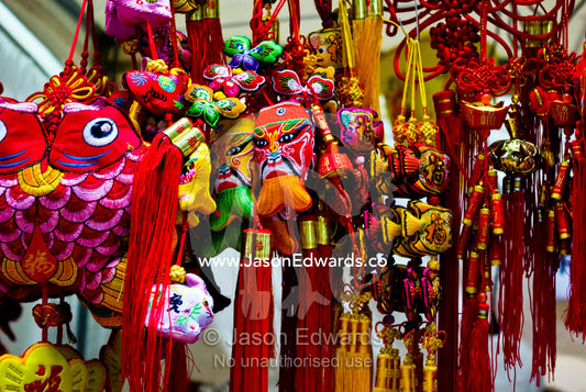 Kites, masks and woven hanging ornaments celebrate Chinese New Year. Chinatown, Melbourne, Victoria, Australia.